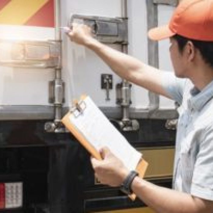 asian-truck-driver-holding-clipboard-his-checking-safety-cargo-container-steel-door_36860-911